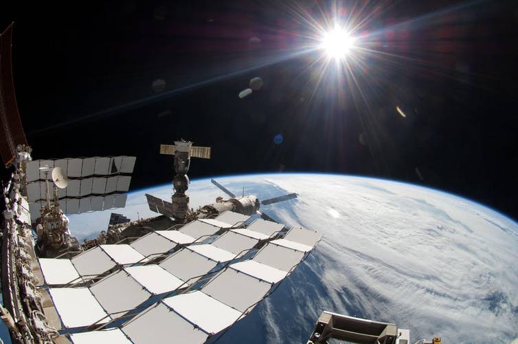 A view of Earth from the International Space Station. The Sun can also be seen in the distance.