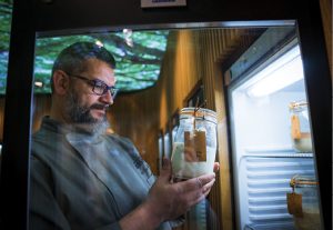 Karl De Smedt looking at one of his sourdough starters in the fridge.